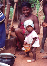 11. Dieudonné's wife observing daughter Hallelujah in a turban