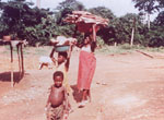 15. Young girl carrying yams on her head