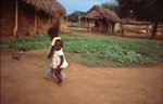 3. Young children walking across the village to buy fried snacks
