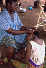 52. Sassandra breast-feeding while his mother has her hair done